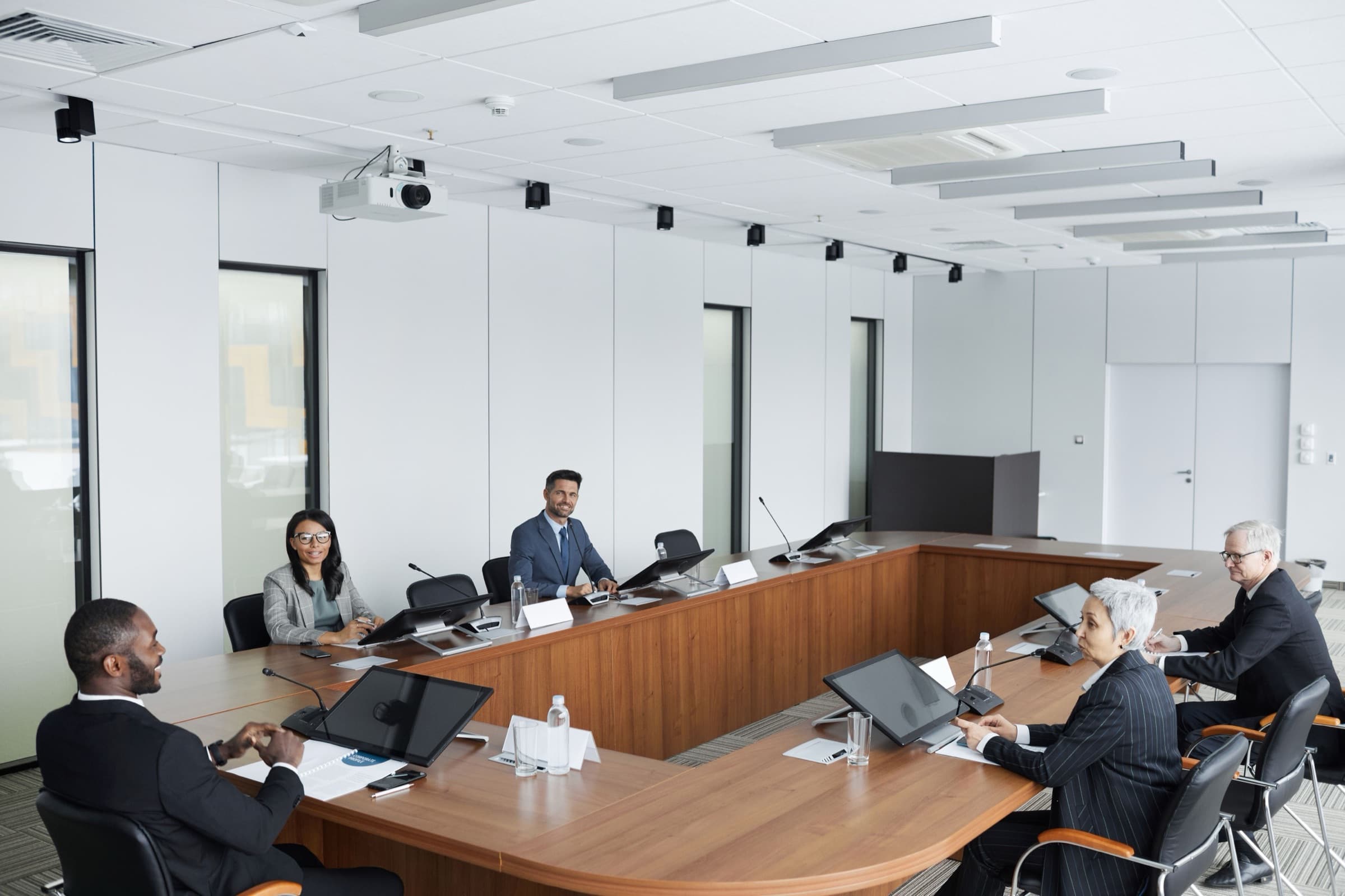 Directors seated around a boardroom table