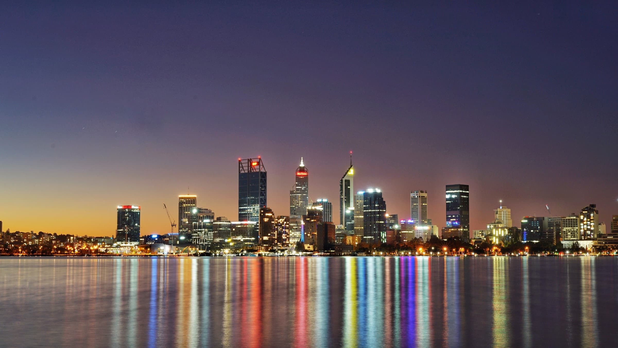 The Perth skyline at night, reflected in the Swan River