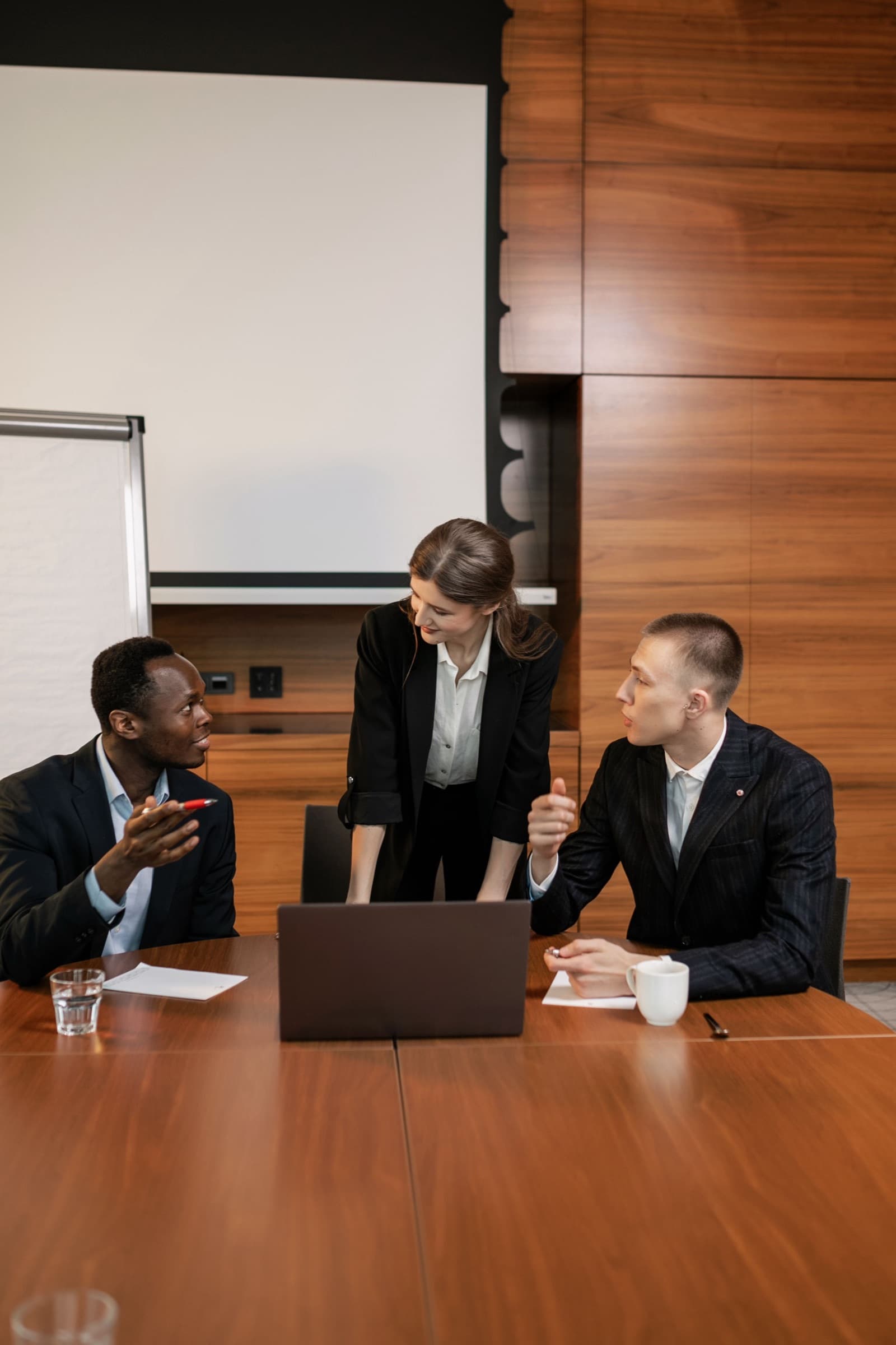 Three colleagues in a working session around a laptop